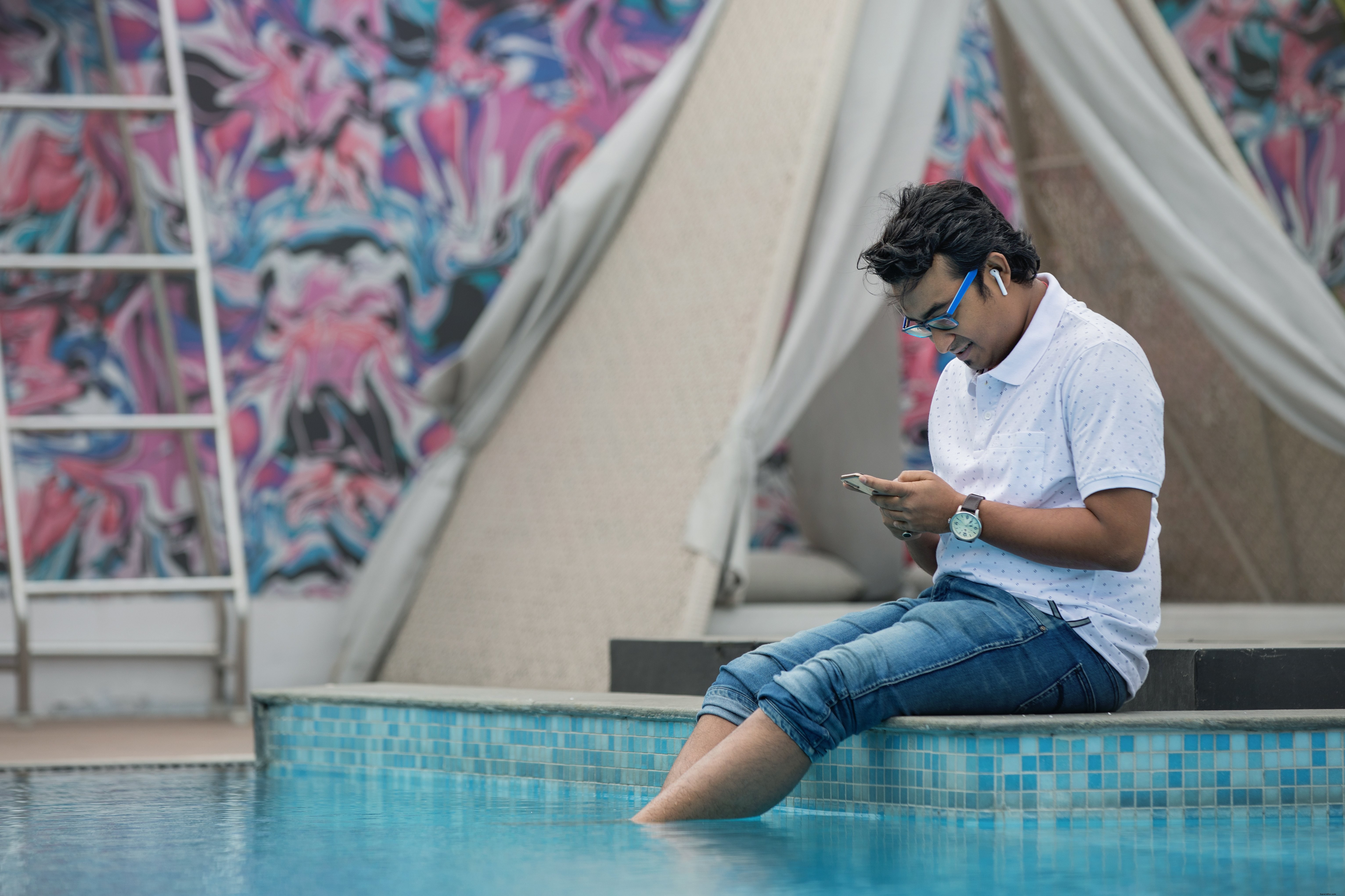 Photo d un homme assis au bord de la piscine