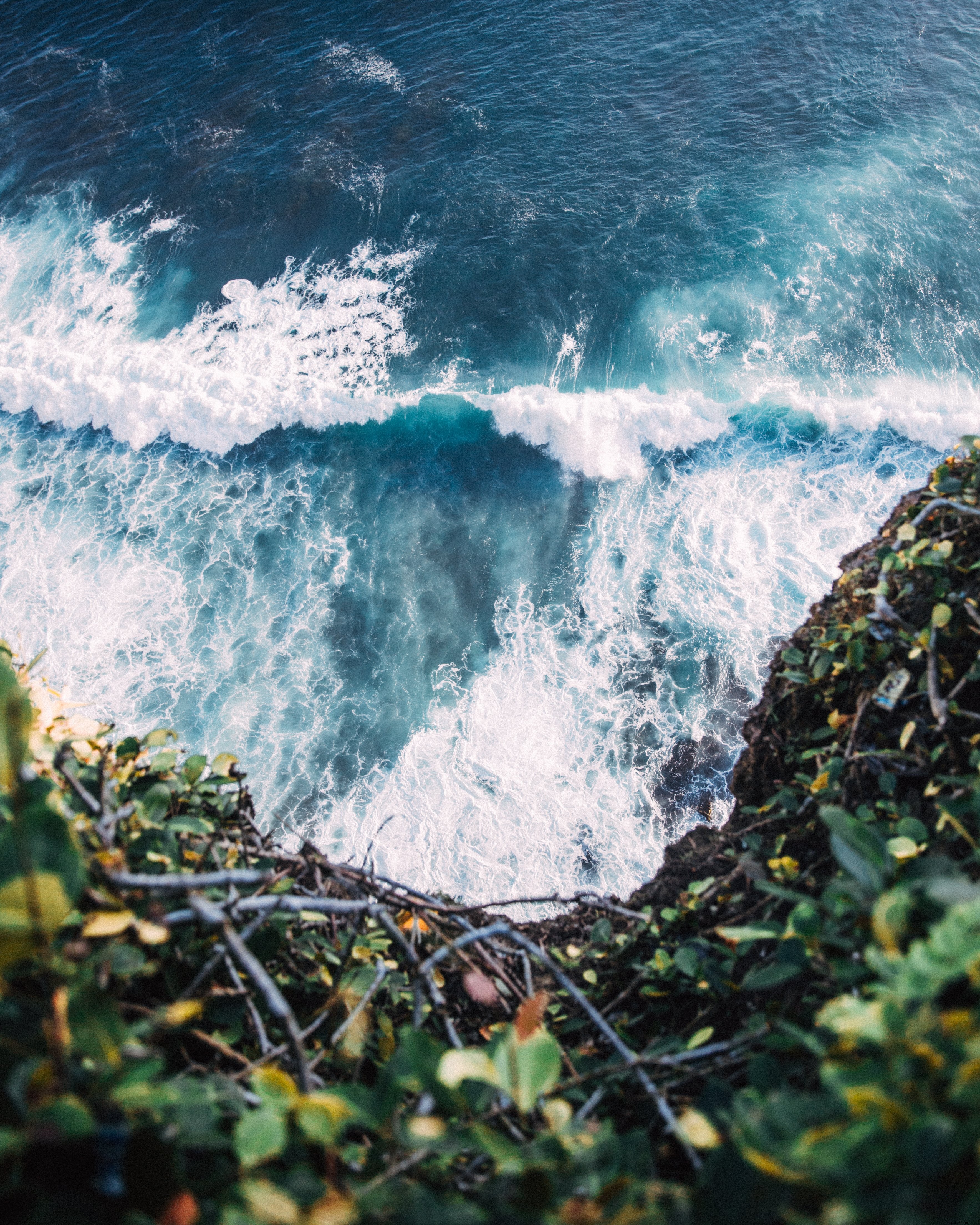 Photo : les vagues bleues se brisent au pied de la falaise