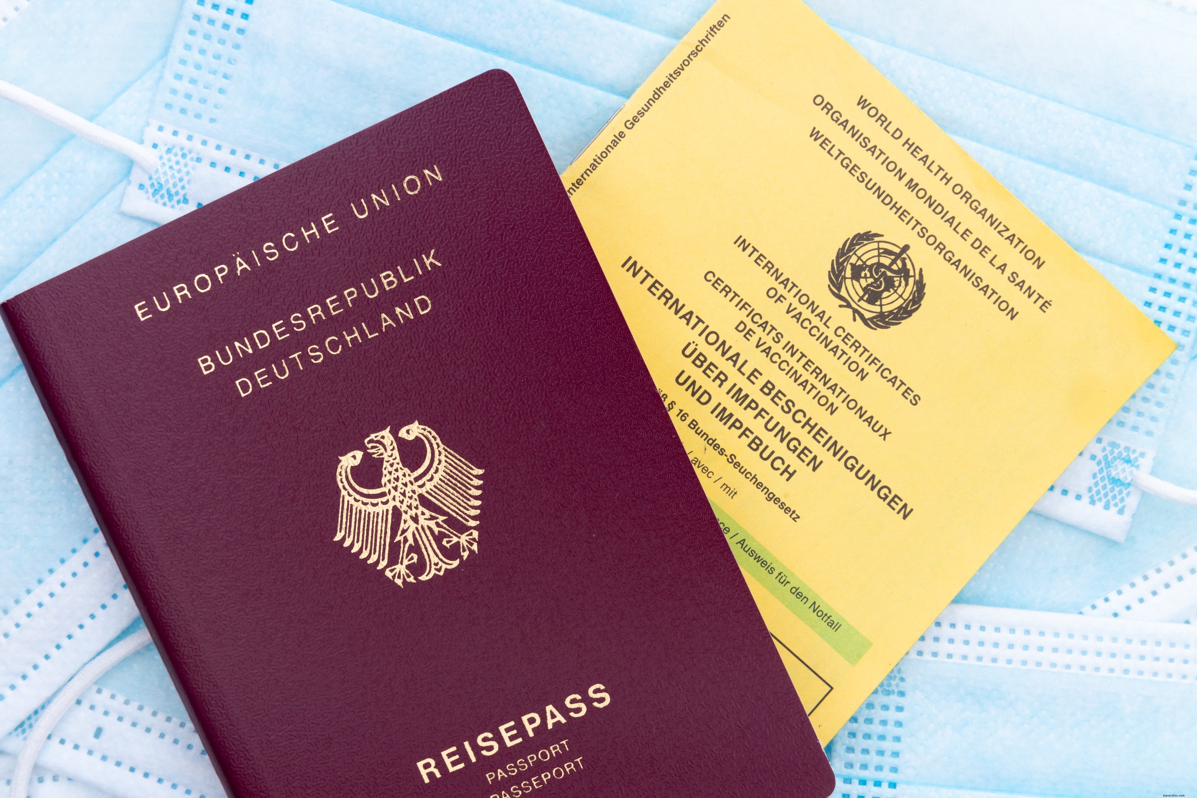 Flatlay d une carte de passeport vaccinal et de masques faciaux