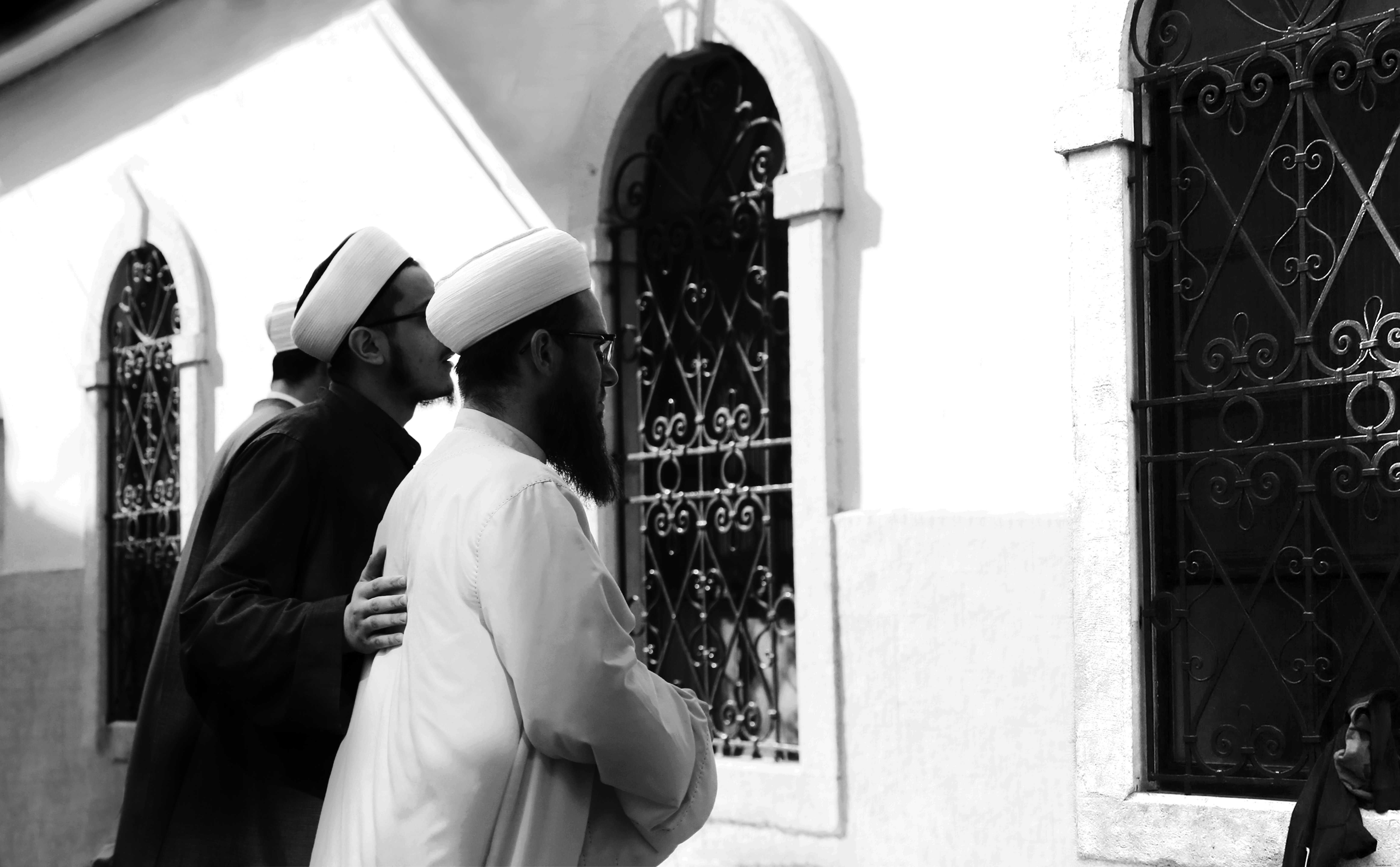 Portrait noir et blanc de deux personnes regardant par la fenêtre